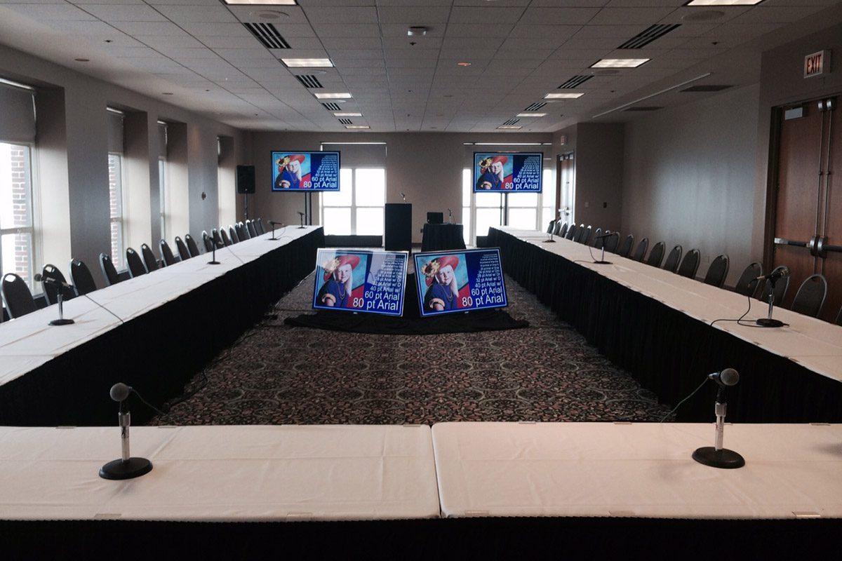 Room With Tables, Microphones & Presentation Screens
