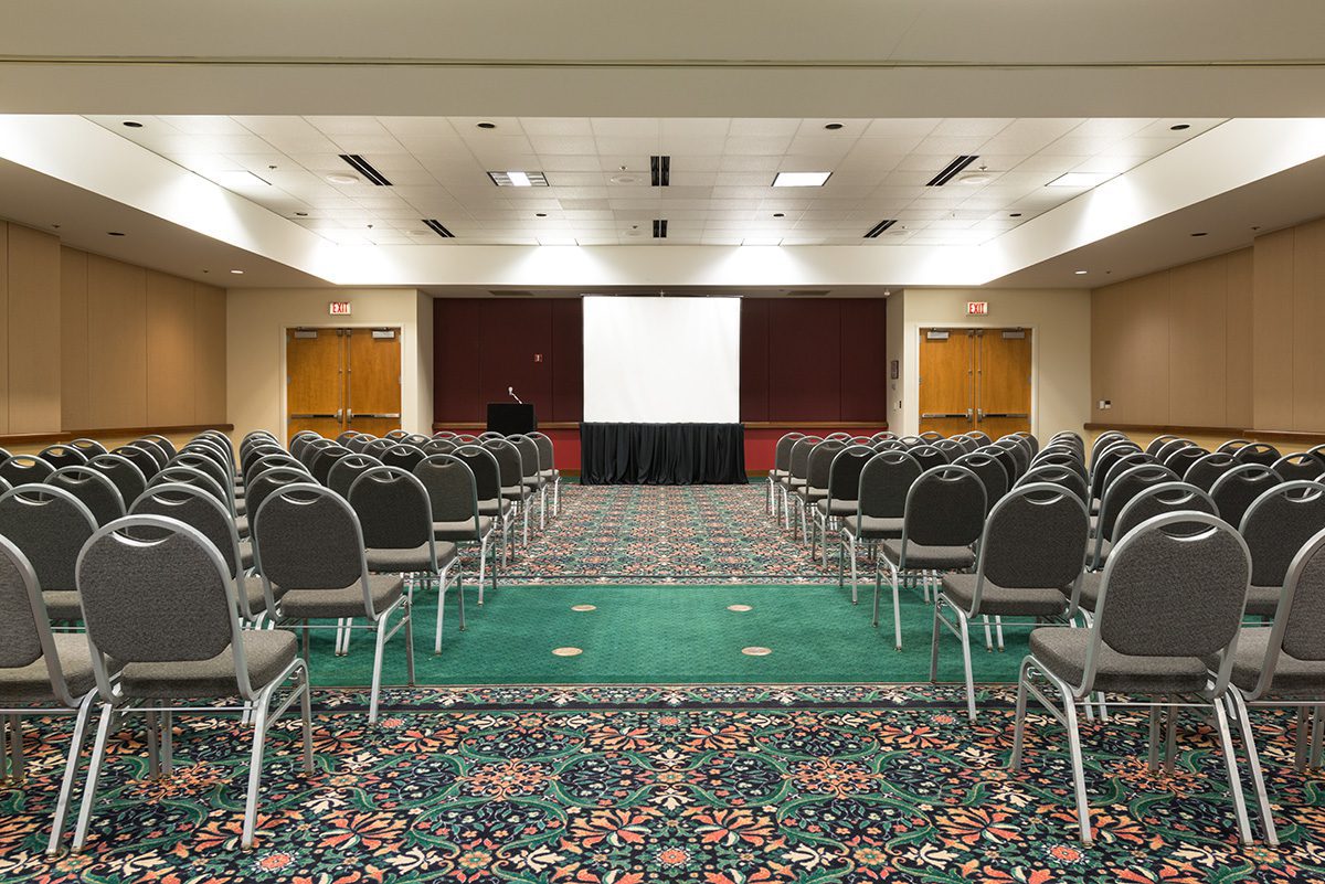 A Meeting Room Set Up With Rows Of Chairs